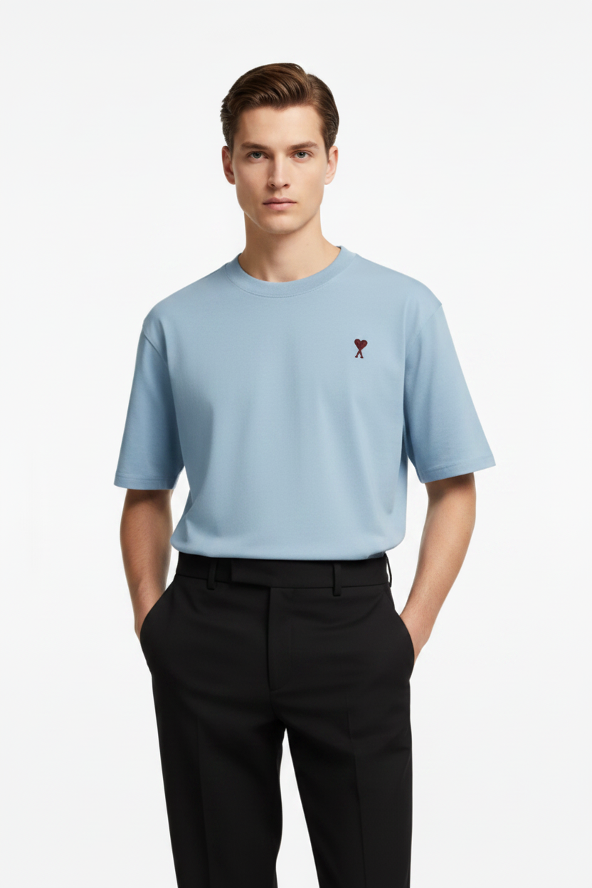 Man wearing light blue t-shirt with red heart logo