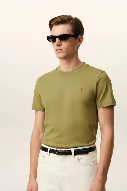 Man wearing olive green t-shirt with red heart-A logo, same photo style